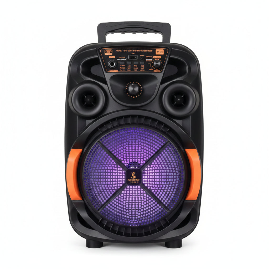 A black portable karaoke speaker with orange accents and a purple front grille stands next to its white retail box. The speaker has multiple speakers, a control panel, and a handle on top.