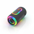 A boxed portable wireless speaker shown in retail packaging, held in a hand. The box features a black cylindrical speaker with rainbow LED lighting and text including '' and 'Colorful Ambient Light'.